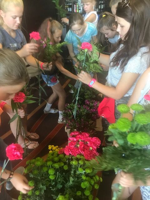 Children from Belarus enjoy making floral presentations for their host families